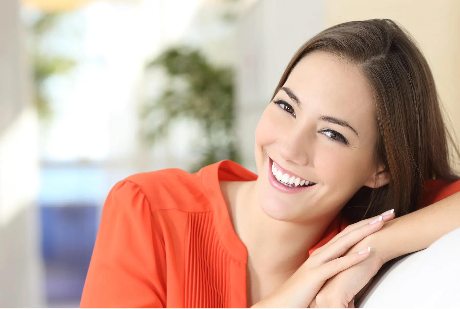 A smiling patient relaxing at home